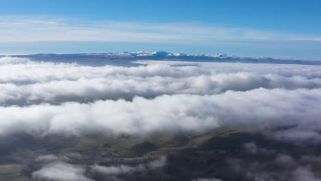 Above-clouds-aerial-view-snowy-Puy-de-Sancy-mountains-volcano-Massif-Central